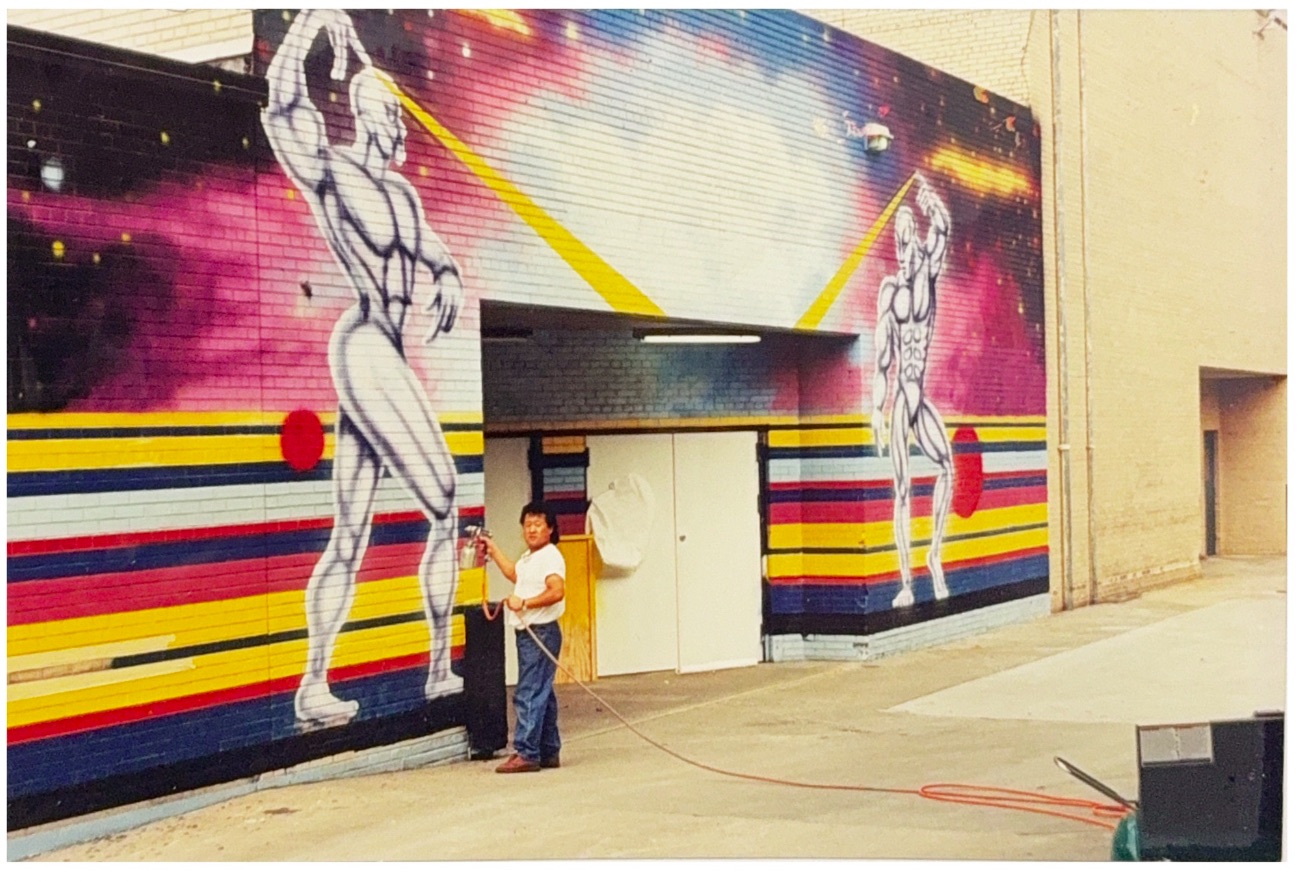 Jong Lee painting a mural in 1996 — founder of Lee's Signs